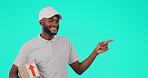 Portrait, delivery and pointing with a black man courier in studio on a blue background holding a package. Logistics, ecommerce and box with a happy male postal worker showing shipping information