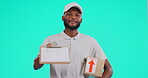 Portrait, delivery and documents with a black man courier in studio on a blue background holding a box. Logistics, ecommerce and package with a happy male postal worker giving paperwork to sign