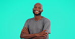 Face, smile and black man with arms crossed in studio isolated on a blue background mockup space. Portrait, confidence and African male person or model from South Africa with happiness for fashion.