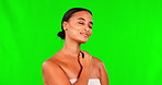 Green screen, happy woman and touch face for skincare, aesthetic glow and soft dermatology on studio background. Female model, natural beauty and shine of confidence, facial spa results and self care
