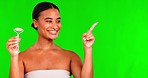 Woman, face roller and pointing on green screen, studio and crystal cosmetics for steps, instructions and how to. Portrait, beauty and female model advertising facial tools, checklist or mockup promo