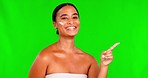 Face, green screen and woman with cream, pointing and dermatology against a studio background. Portrait, female person or model with hand gesture, choice and lotion with beauty, skincare or cosmetics