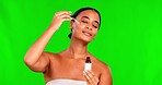 Woman, green screen and oil serum for face, aesthetic skincare and dermatology on studio background. Female model, facial cosmetics product and dropper for hyaluronic acid, liquid collagen and beauty