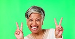 Laughing, peace sign and face of woman on green screen in studio isolated on a background. Portrait, senior and person with v hand gesture for applause, funny and excited, happy or emoji for comedy