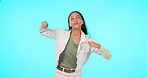 Young woman is dancing, portrait with energy and carefree, mockup space and happiness isolated on blue background. Youth, gen z and female dancer, cool and stylish with freedom and laughter in studio