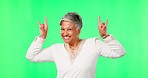 Funny, face and senior woman in green screen, rock hands or emoji for winning, success and celebration, Excited, crazy and fun elderly indian person dancing or celebrate isolated on studio background