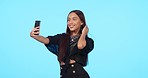 Selfie, smile and beauty of woman in studio isolated on a blue background mockup. Self photography, fashion and stylish female person or influencer with profile picture, social media and happy memory