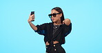 Selfie, fashion sunglasses and woman in studio isolated on blue background mockup. Self photography, beauty or stylish female person, influencer and profile picture, social media or cool aesthetic.