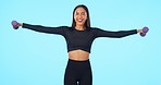 Happy woman, fitness and weightlifting dumbbell on mockup in workout against a blue studio background. Portrait of fit or active female person lifting weights with smile in exercise on mock up space