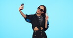 Selfie, sunglasses and woman with peace sign in studio isolated on a blue background mockup. Self photography, v hand gesture and stylish person or influencer with profile picture, fashion and emoji.