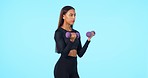 Woman, fitness and weightlifting dumbbells on mockup for workout against a blue studio background. Serious, fit and active female person lifting weights for training or arm exercise on mock up space