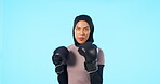 Portrait, woman and boxer in blue studio background with hijab and gloves for a workout and training. Female athlete, boxing and wellness for exercise and fitness with islamic person in a gym.