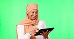 Muslim, woman and happy on tablet in studio for social media, ecommerce or streaming on green screen for technology. Islamic person, hijab and laughing on internet, app or web communication mock up