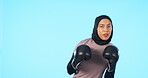 Woman, boxer and portrait in blue studio background with muslim for fitness, workout and wellness. Female boxing, athlete and gloves with training face and hijab for exercise in a fight at the gym.