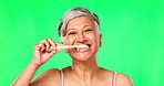 Green screen, mature woman or brushing teeth with dental toothpaste for healthy oral hygiene grooming. Eco friendly, cleaning portrait or senior person with a bamboo toothbrush for teeth whitening