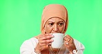 Woman, hijab and thinking in green screen studio with coffee cup, worry and remember with smile for mockup. Mature islamic model, chromakey mock up and drink for matcha, latte and memory of ideas