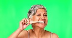 Green screen, senior woman or brushing teeth with dental toothpaste for healthy oral hygiene grooming. Eco friendly, cleaning portrait or mature person with a bamboo toothbrush for teeth whitening