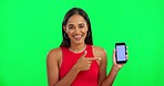 Woman, green screen and point at phone, face and mockup space for logo, branding or review with smile. Girl, model or  young student with smartphone, pointing and happy for promotion with mobile app