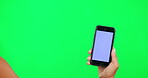 Phone, mockup and hand of a person on green screen for website, internet or network promo. Hands of a model with a smartphone for online advertising, ux or ui information on a studio background