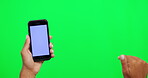 Phone, mockup and touch with hand on green screen for website, internet or network promo. Hands of a person typing on a smartphone for online advertising, ux or social media on a studio background