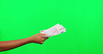 Giving, money and person hand on green screen or studio background for financial loan, payment or bonus. Cash, offer and people in finance, banking and lottery or giveaway, salary and profit increase