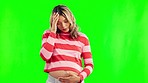Pregnant, pain and woman with stress on green screen in studio with anxiety, worry and headache. Pregnancy, health and female person on chromakey background with contractions, problem and strain
