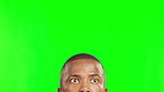 Green screen, announcement and black man search or peeking to discover, explore and isolated in a studio background. Thinking, wow and young person looking or searching for adventure or notification