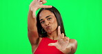 Happy woman, hands and frame on green screen for photography against a studio background. Portrait of female person with smile or hand framing face of photographer in photo or capture on mockup space