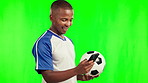 Football, sports and black man with phone on green screen in studio isolated on a background mockup. Soccer, mobile and happy African athlete with ball for workout, training or exercise for fitness.