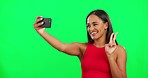 Green screen, selfie and woman with a peace sign, smile and social media against a studio background. Female person, model and girl with a smartphone, happiness and v gesture with joy and connection