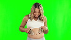 Excited, baby shoes and happy pregnant woman on green screen with belly growth and development. Pregnancy, mother or young person with newborn clothes to imagine or thinking of future outfit choice
