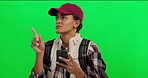 Phone, tourist and woman in a studio with green screen looking for direction with online map. Backpack, travel and young female person with a cellphone or mobile isolated by a chroma key background.