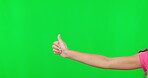 Child hands, thumbs up and approval on green screen for winning against a studio background. Hand of female kid and thumb emoji, yes sign or like for win, good job or success in achievement on mockup