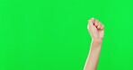 Person, hands and fist in protest on green screen for democracy, equality or violence against a studio background. Hand of child, kid or activist with fists in protesting or fight on mockup space