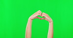 Person, hands and heart sign on green screen for love, care or advertising against a studio background. Hand of child or kid showing loving symbol, shape or icon for compassion on chromakey mockup