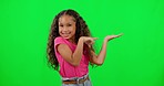 Green screen, face and girl with a smile, pointing and showing against a studio background. Portrait, female child and young person with hand gesture, excited and decision with opportunity and choice