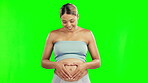 Pregnancy, green screen and pregnant woman with love, heart and care for baby and touch her stomach. Wellness, shape and young female person hands on belly for childcare, support and happy for future