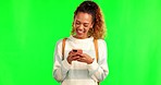 Happy woman, typing and laughing with phone on green screen for joke or meme against a studio background. Female person smile and laugh on mobile smartphone for funny chat, texting or social media