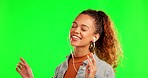 Happy woman, dance and listening to music on green screen against a studio background. Female person with earphones dancing and enjoying audio, streaming or sound track for fun time on mockup space