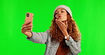 Happy woman, selfie and peace sign for photo on green screen against a studio background. Female person with smile and facial expressions for memory, vlog or online social media on chromakey mockup