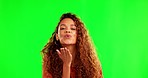 Green screen, woman and kiss gesture for flirting in a studio for love and romantic expression. Happy, smile and portrait of a female model with a flirty personality isolated by chroma key background
