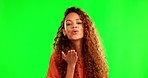 Green screen, woman and blow kiss in a studio for love, happiness and romantic expression. Happy, smile and portrait of a female model with a flirty personality isolated by a chroma key background.