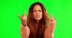 Angry young woman, middle finger and green screen with frustrated face, hand sign and mockup by background. Girl, student and annoyed with icon, emoji and fuck you for opinion, voice and portrait