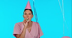 Birthday, happy and balloons with a nurse woman in studio isolated on a blue background for a celebration event. Portrait, healthcare and a young female medicine professional blowing a party horn