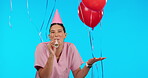 Birthday, party horn and balloons with a woman nurse in studio isolated on a blue background for celebration. Portrait, healthcare and a happy female medicine professional blowing on a noisemaker