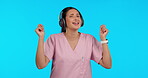 Music, dance and headphones with a nurse woman in studio isolated on a blue background for healthcare. Medical, audio and streaming with a young female medicine professional listening to the radio