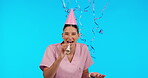 Birthday, funny and balloons with a nurse woman in studio isolated on a blue background for celebration. Smile, healthcare and a happy female medicine professional blowing a party horn at an event