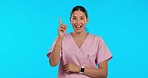 Face, thinking and nurse with solution, woman and employee against a blue studio background. Portrait, female person and medical professional with ideas, problem solving and healthcare with decision