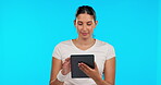 Tablet, app and smile with a woman on a blue background in studio for social media browsing. Research, technology and connection with a happy young female surfing the internet for online information