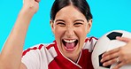 Face, soccer and woman winning, celebration and athlete against a blue studio background. Portrait, female person and football player with happiness, champion or winner with fitness, success and goal